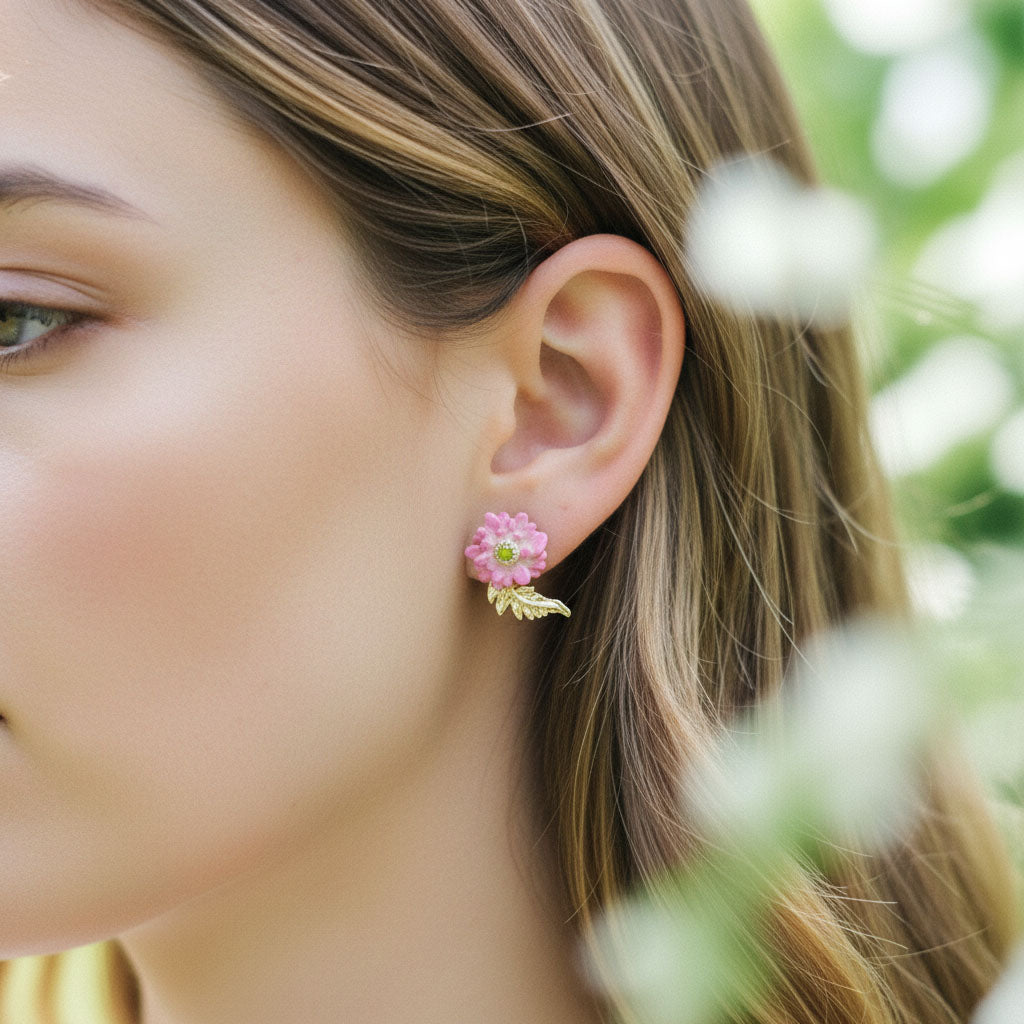 Close-up of a woman wearing a floral earring with a blurred natural background