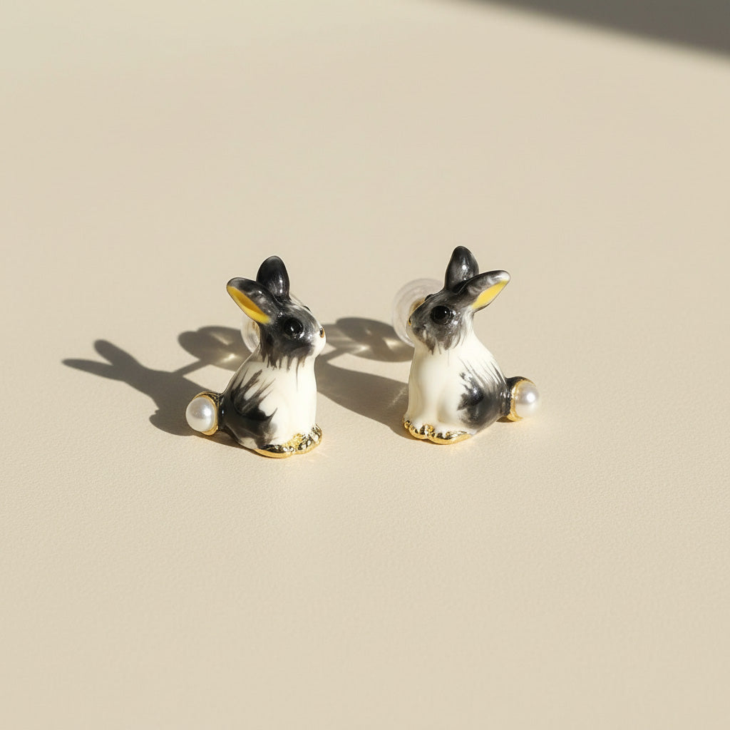 Pair of dog-shaped earrings on a beige background