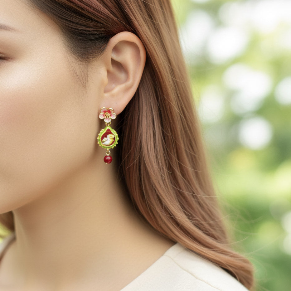 Close-up of a woman wearing a decorative earring with a blurred green background