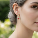 Close-up of a woman wearing a floral earring with a blurred green background