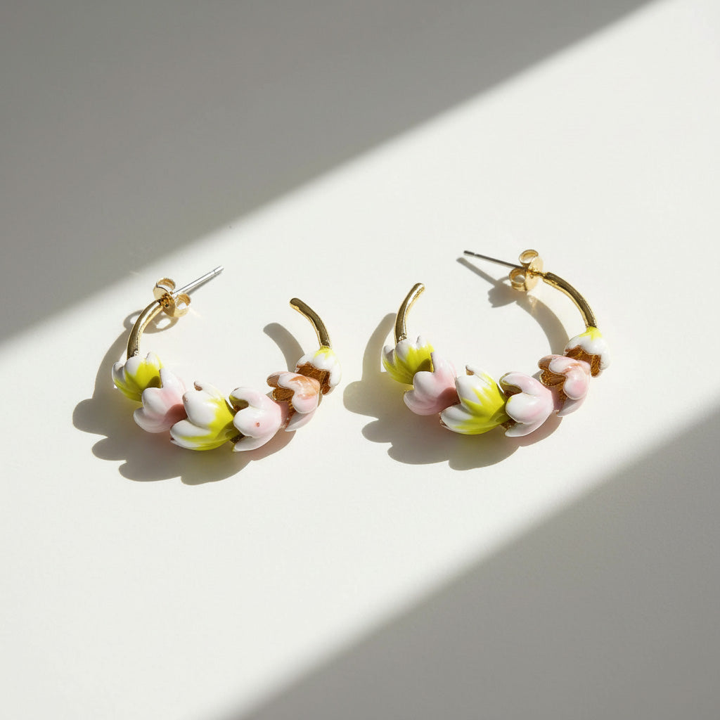 Pair of hoop earrings with floral design on a light background