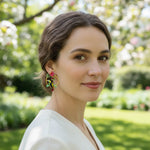 Woman wearing colorful earrings in a garden setting