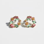 Floral hoop earrings on a light background