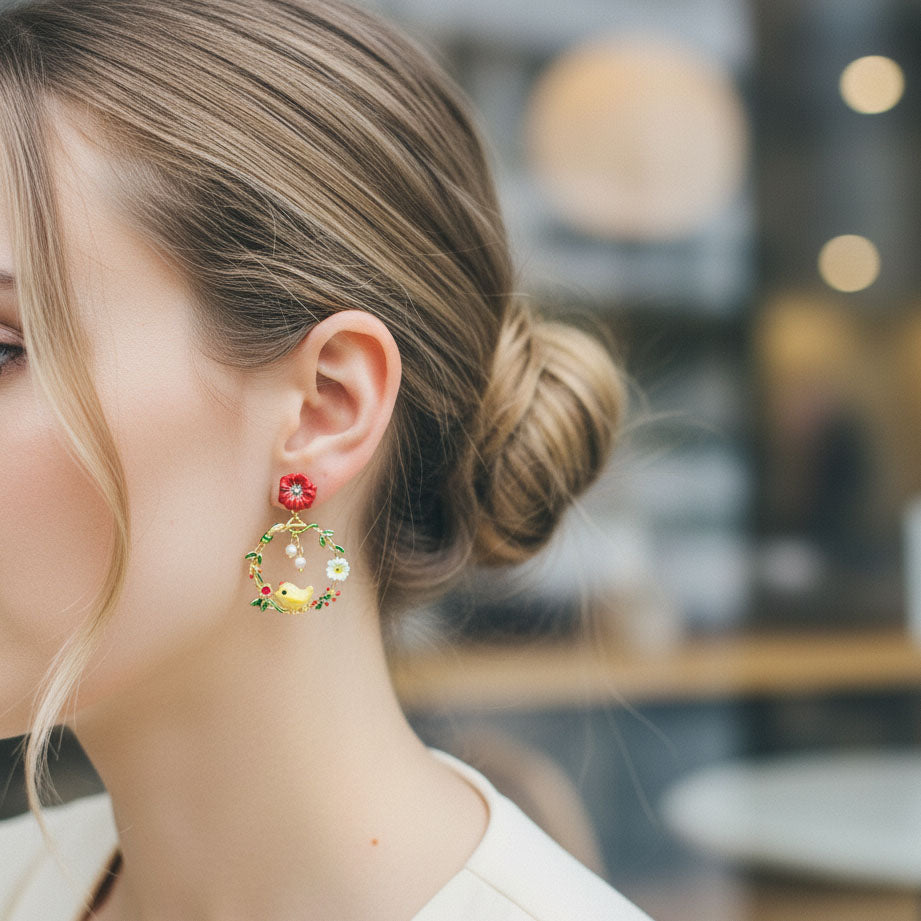 Close-up of a woman wearing colorful floral earrings with a blurred background