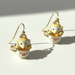 Pair of monkey earrings on a white background