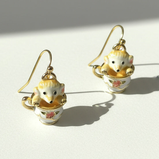 Pair of monkey earrings on a white background