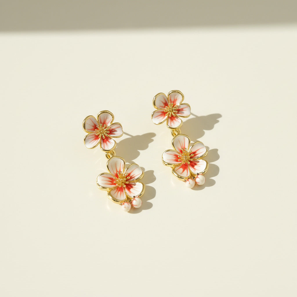 Floral earrings with gold accents on a beige background
