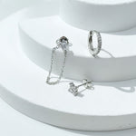 Silver earrings on a white surface