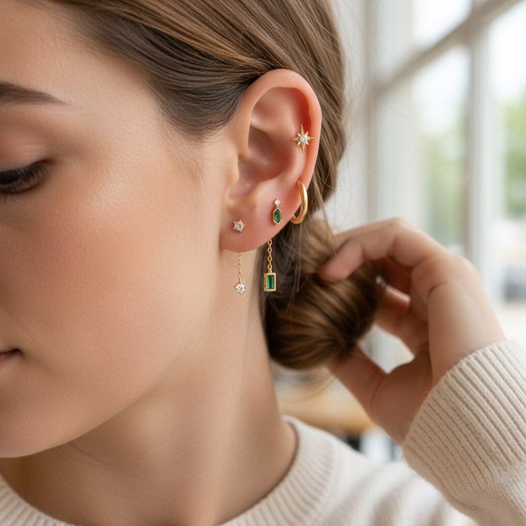 Close-up of a woman wearing multiple earrings with a blurred background