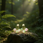 Jewelry set on a rock with sunlight filtering through trees