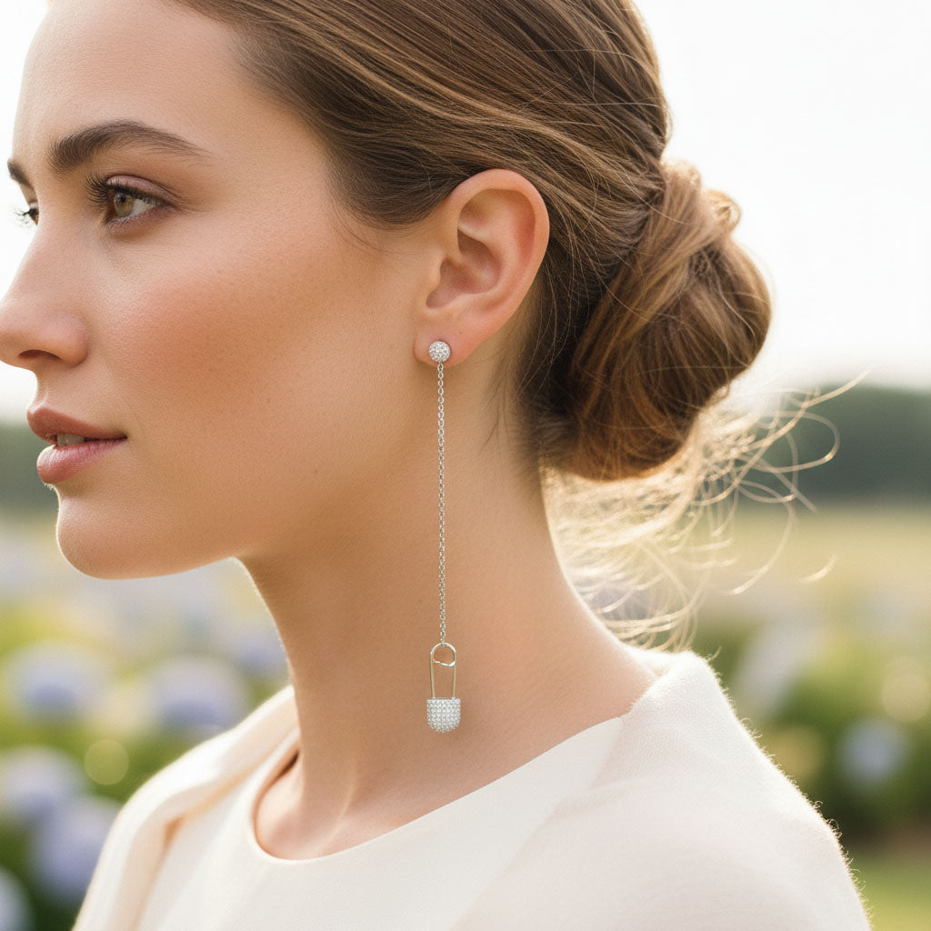 Woman wearing a silver earring with a blurred outdoor background