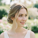 Bride with porcelain pearl hair comb styled in romantic low bun, A2K London.
