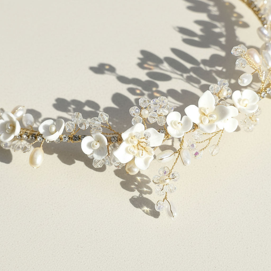 Close-up of porcelain flowers, pearls, and glass crystals on gold-plated tiara.