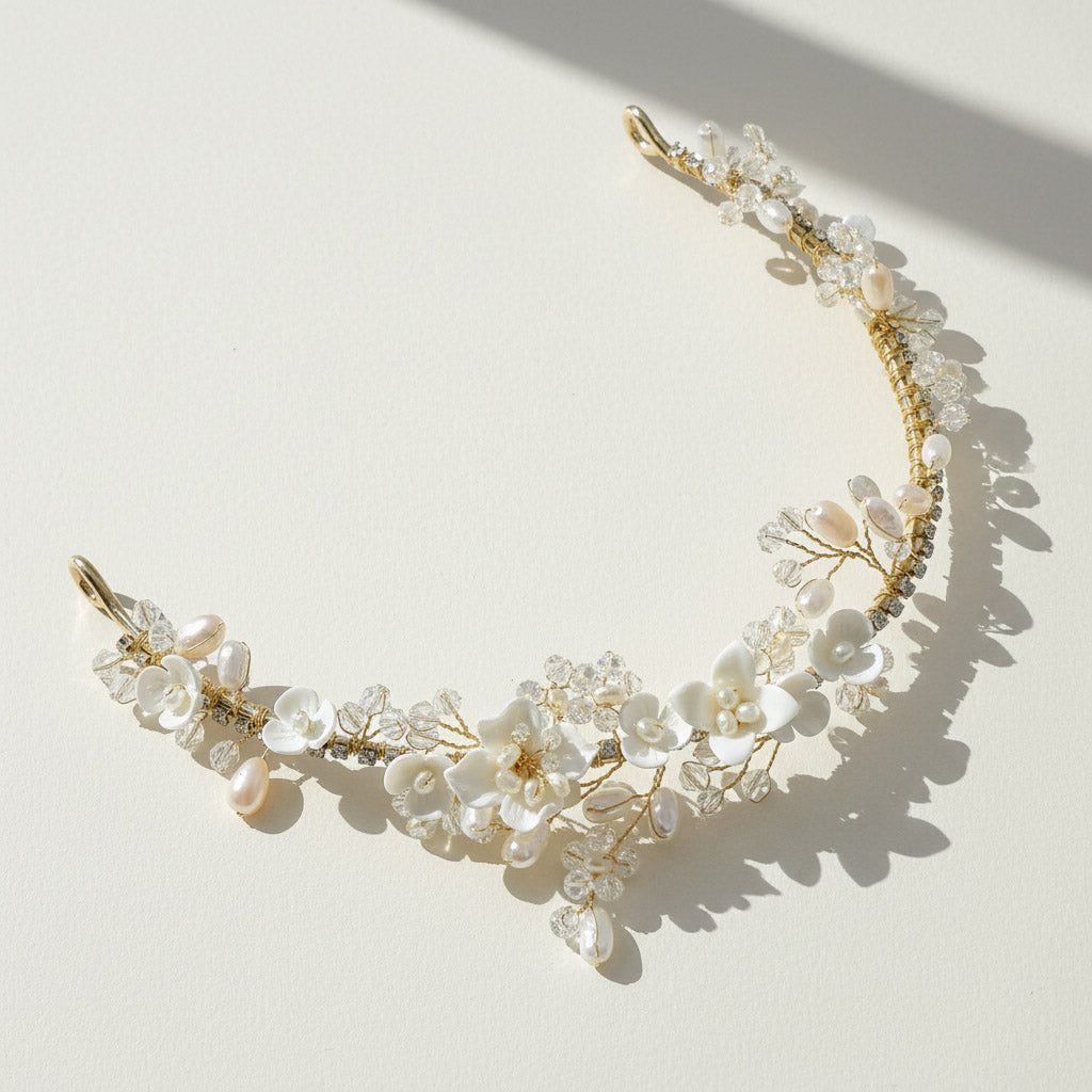 Bride wearing handcrafted porcelain and pearl tiara in garden setting.