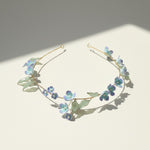 Floral headband with small flowers and leaves on a light background