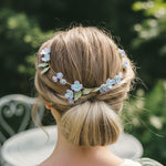 Woman with a floral hair accessory in her bun outdoors