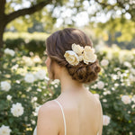 Bride wearing hand-painted magnolia bridal hairpins in low bun, garden setting.
