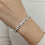 Model wearing platinum moissanite tennis bracelet on wrist