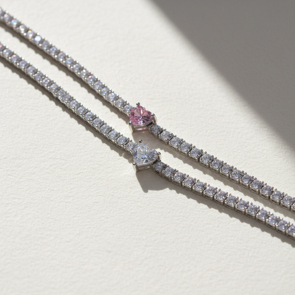 Close-up of moissanite tennis bracelets with white and pink heart center stones