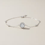 moissanite halo bracelet in platinum plated sterling silver on neutral background