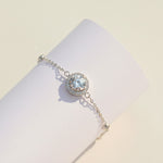 Close-up of 1ct D/VVS1 moissanite halo center stone bracelet in platinum plated sterling silver