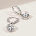 Side view of halo lab-grown diamond drop earrings with silver hoops