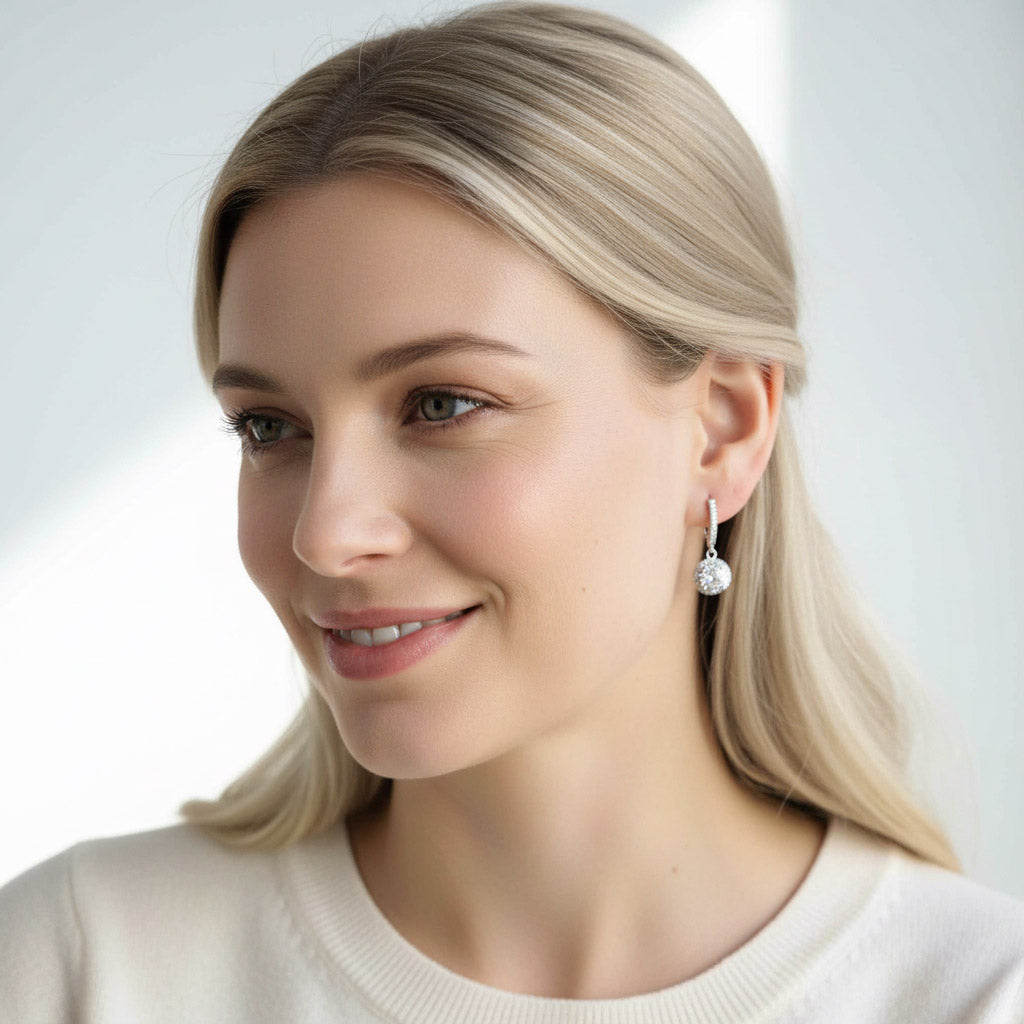 Model wearing sterling silver halo diamond drop earrings, 2ct total weight
