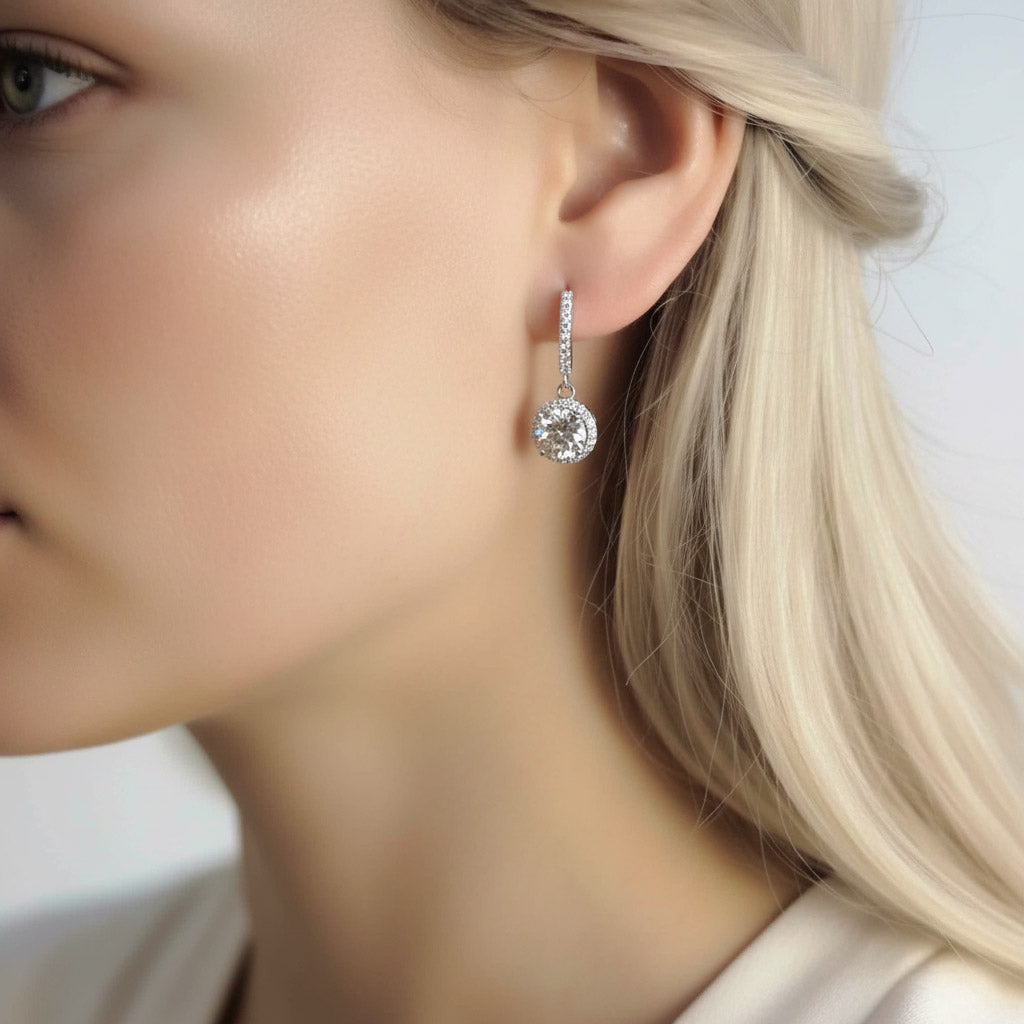 Close-up of lab-grown diamond halo earrings in polished sterling silver hoops