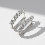 Close-up of sterling silver hoops featuring 1.2ct+1.2ct D/VVS1 lab-grown diamonds