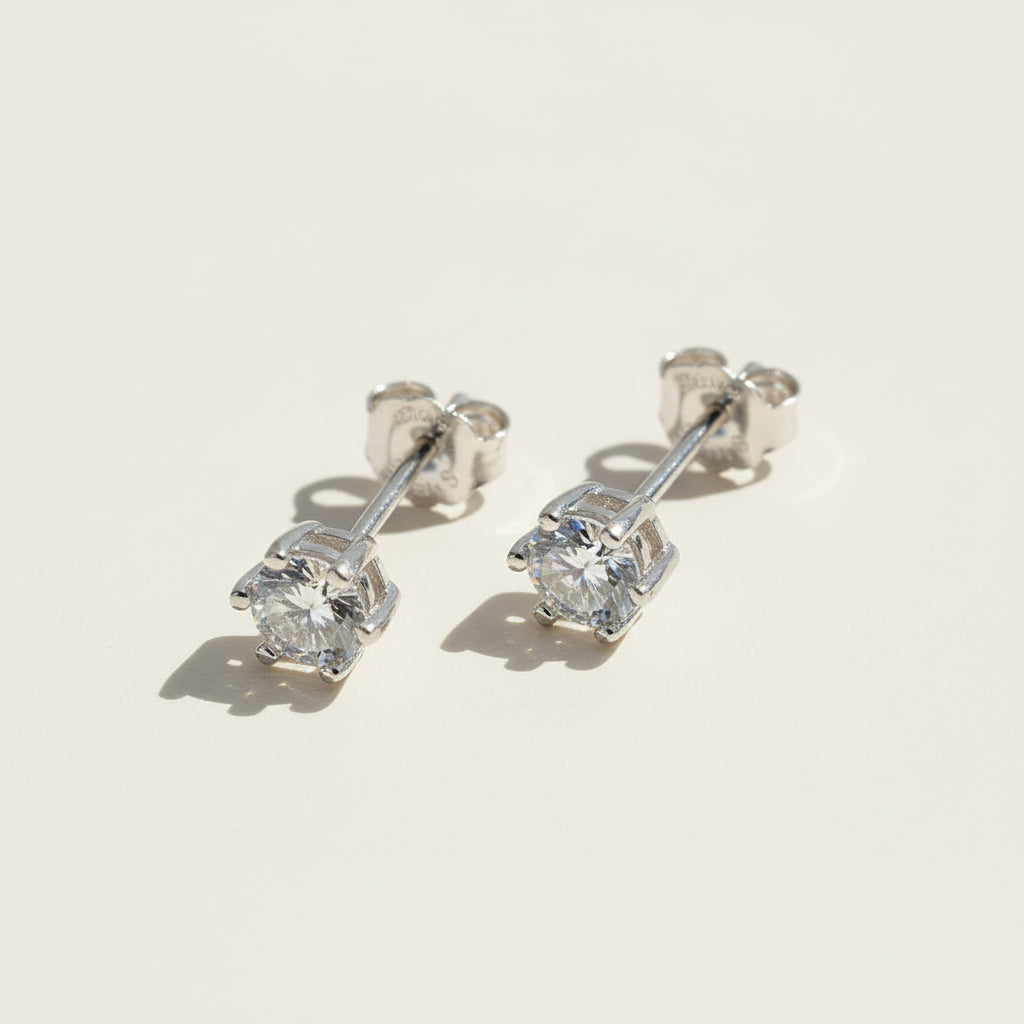 Round lab-grown diamond stud earrings with silver butterfly backs for pierced ears