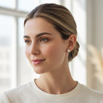 Model wearing platinum-plated silver 1.0 ct lab-grown moissanite stud earrings, D/VVS1 clarity