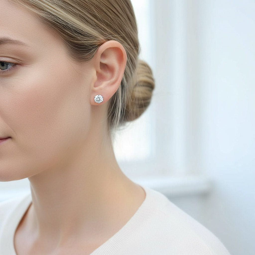 Model showcasing platinum-plated moissanite stud earrings, brilliant-cut 1.0 ct stones