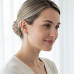 Model wearing platinum-plated sterling silver CZ stone hoop earrings, elegant minimalist design