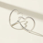 Heart-shaped sterling silver hoop earrings with sparkling pavé diamonds, open design