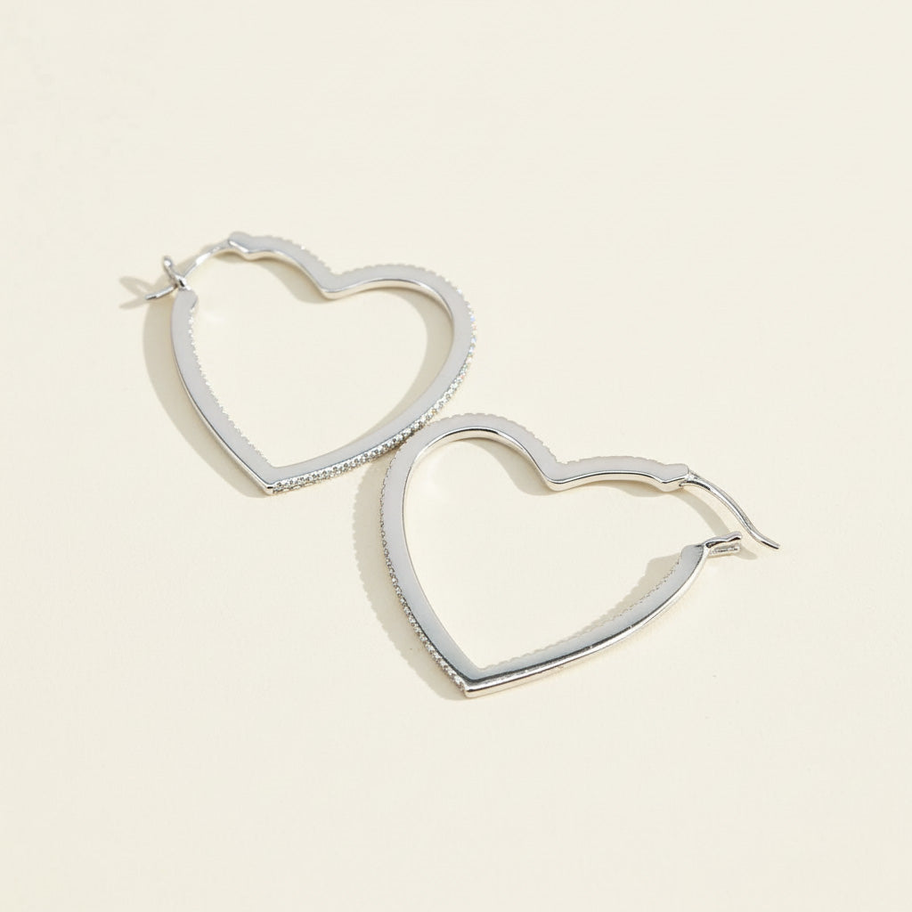 Silver heart-shaped hoop earrings featuring lab-grown diamond pavé, romantic minimalist style
