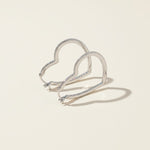Sterling silver pavé diamond heart hoops, elegant lightweight earrings with modern silhouette.