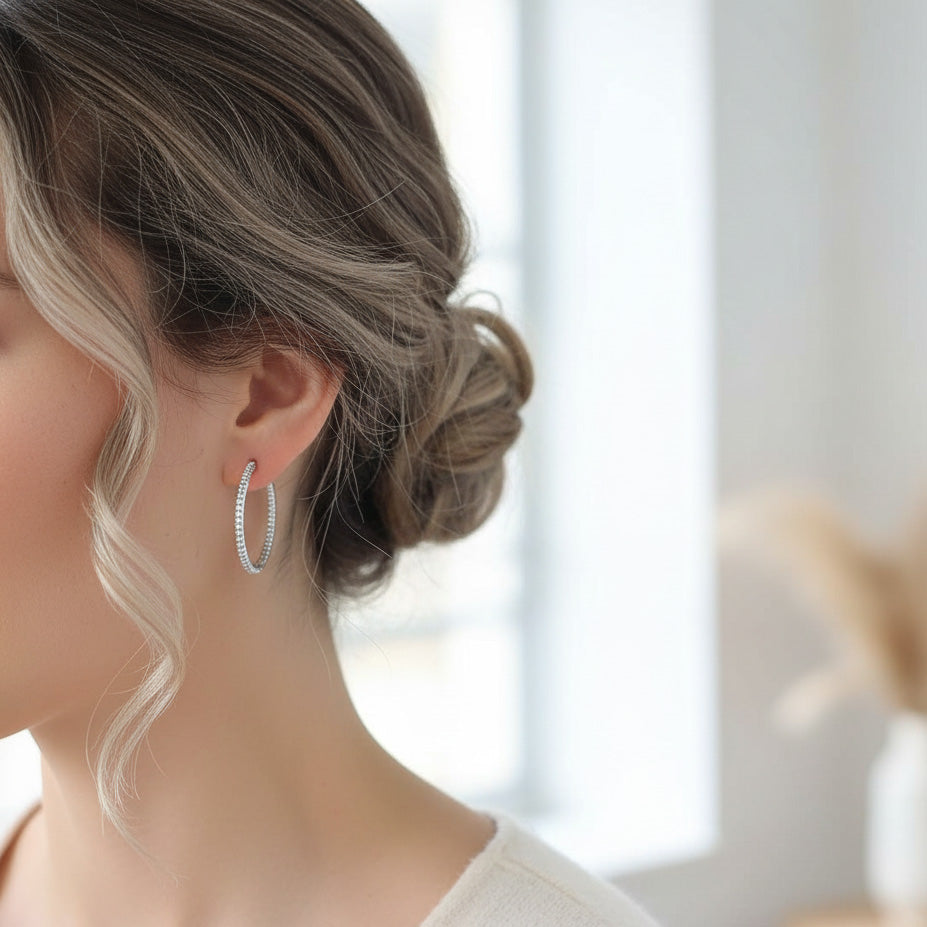 Model wearing 30mm platinum-plated sterling silver moissanite hoop earrings, side profile, soft natural lighting