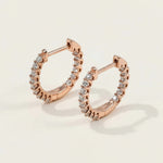 Rose gold-plated sterling silver hoop earrings featuring lab-grown moissanite stones in a full circle claw setting.