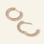 Back view of rose gold-plated sterling silver hoop earrings with lab-grown moissanite stones in claw settings