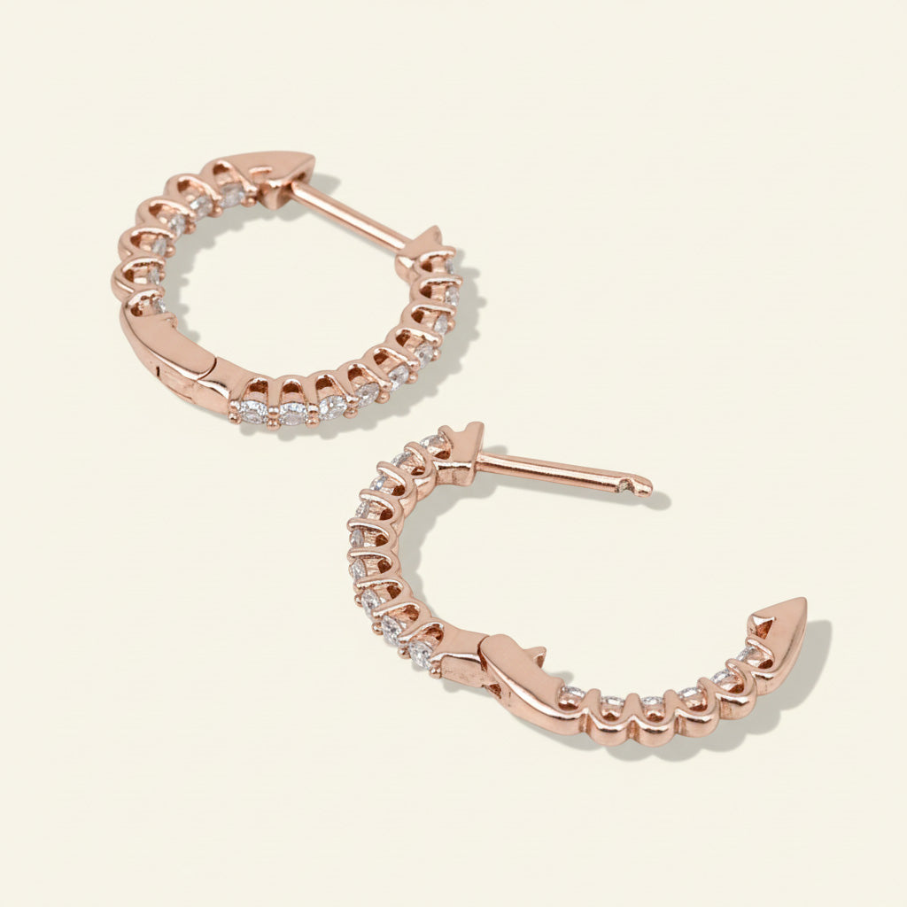 Back view of rose gold-plated sterling silver hoop earrings with lab-grown moissanite stones in claw settings