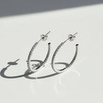 23mm inside-out moissanite hoop earrings on white background