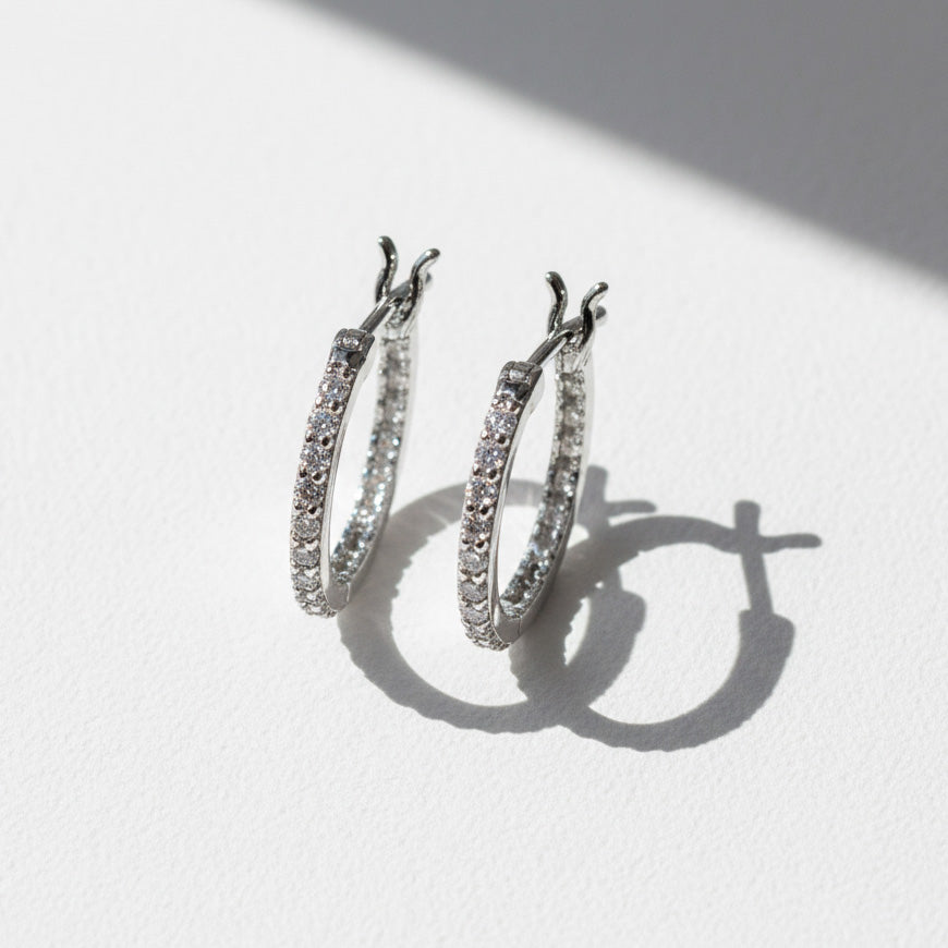 Close-up of platinum S925 inside-out moissanite hoops with pavé stones