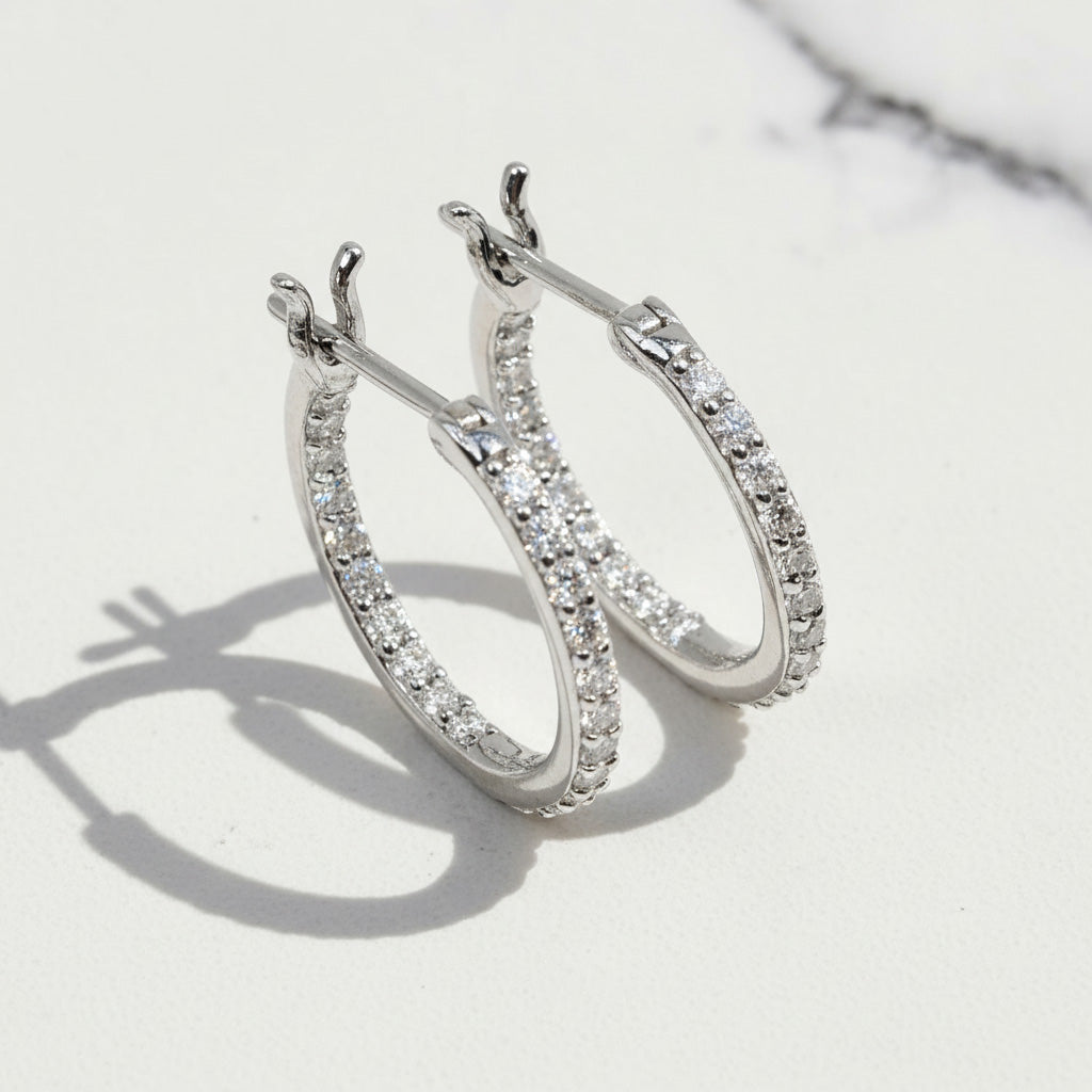 Platinum-plated sterling silver hoop earrings with inside-out moissanite stones.
