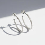 Close-up of platinum S925 moissanite hoop earrings with inside-out stones