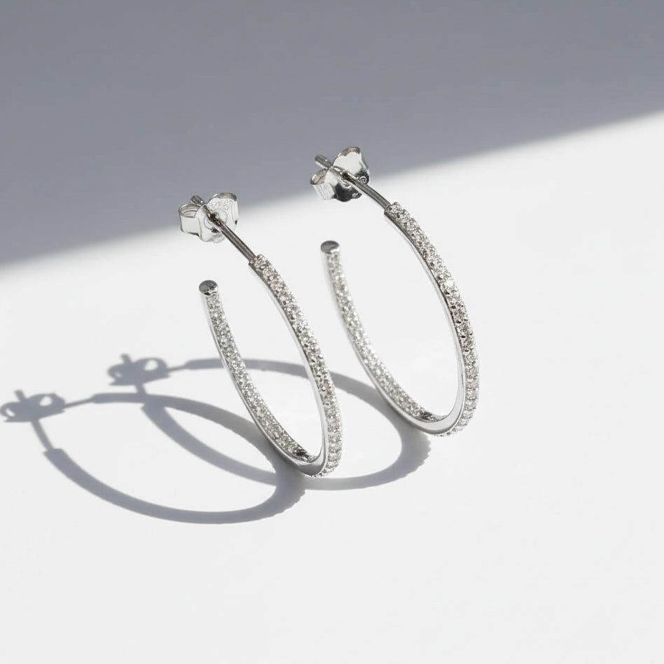 Close-up of platinum S925 moissanite hoop earrings with inside-out stones