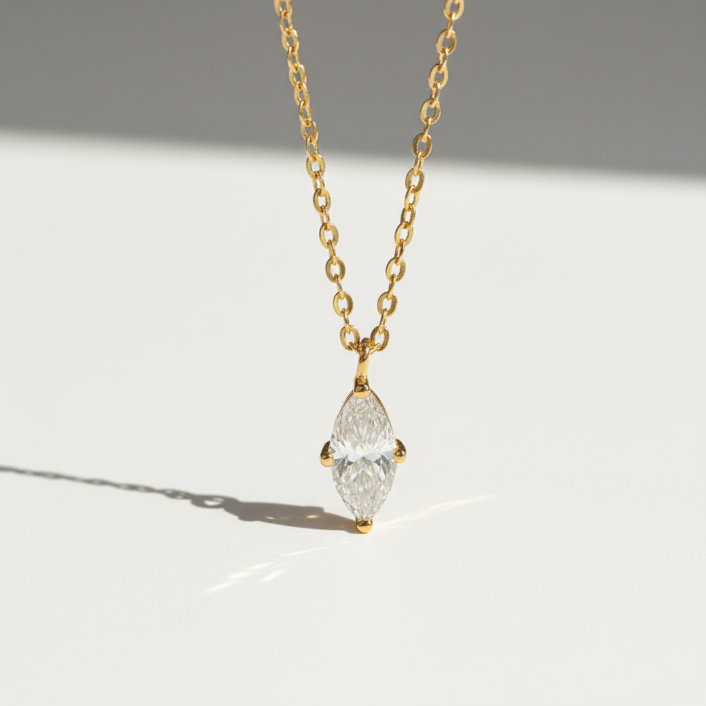 Gold-plated marquise 1ct D/VVS1 moissanite necklace on a clean sunlight background