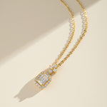 Gold-plated emerald-cut D/VVS1 moissanite halo necklace on a soft warm background