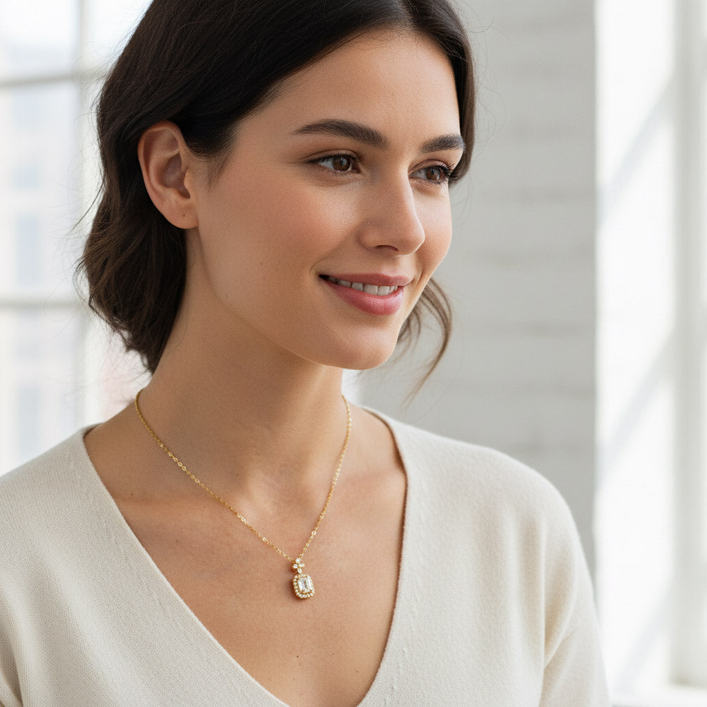 Woman wearing gold-plated emerald-cut halo moissanite necklace in natural light