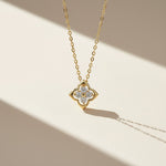 Close-up of gold-plated moissanite clover necklace under natural sunlight