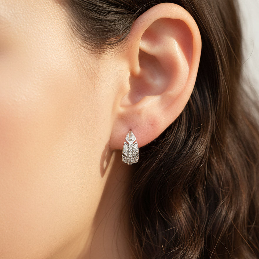 Model wearing sterling silver leaf moissanite hoop earrings